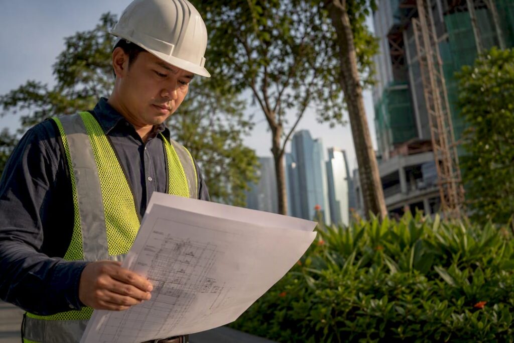 Engineer examining building plans at construction site