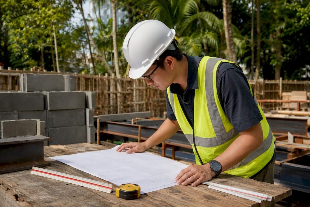 Engineer overlaying sewerage plan and survey