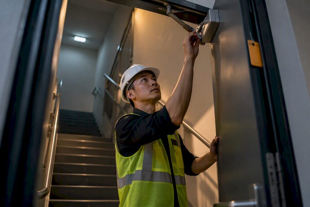 Inspector checking fire-rated stairwell door